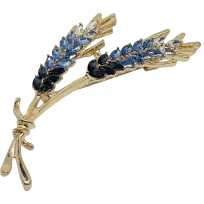 Prendedor dorado con azul y brillantitos