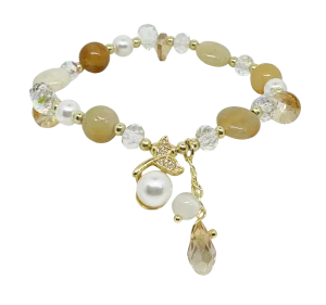 Pulsera elástica de vidrio beige con dije cola de sirena